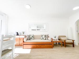 a living room with a couch and a table at Apartment Praia Rocha Candimar Salvia in Portimão