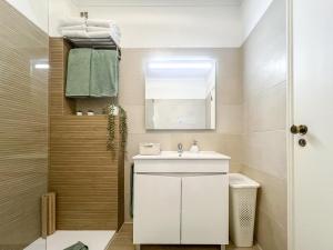 a small bathroom with a sink and a mirror at Apartment Praia Rocha Candimar Salvia in Portimão +25 photos