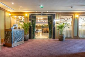 a lobby of a hotel with potted plants at Grand Mogador City Center in Casablanca