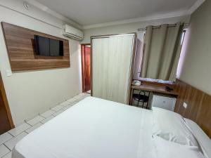 Postel nebo postele na pokoji v ubytování Hotel Parati Arapongas