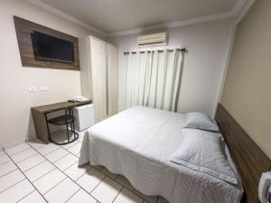 Postel nebo postele na pokoji v ubytování Hotel Parati Arapongas