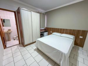 Postel nebo postele na pokoji v ubytování Hotel Parati Arapongas