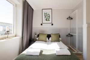 a bedroom with a bed with two pillows at ShortStayPoland Apartamentowa B180 in Warsaw