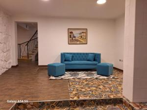 a blue couch in a room with a staircase at Resplendor Hotel in Viña del Mar