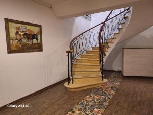 a staircase in a house with a painting on the wall at Resplendor Hotel in Viña del Mar