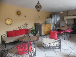 a living room with a couch and a table at Gîte Ô Pois Papillon in Saint-Sornin