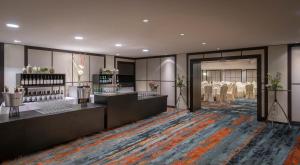 a rendering of a salon with tables and chairs at Clayton Hotel Düsseldorf City Centre in Düsseldorf