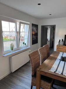 a dining room with a table and some windows at Ferienhaus Berg in Birstein