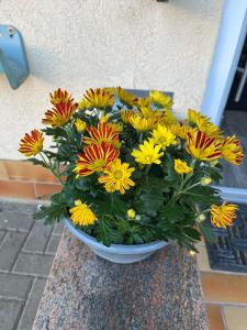 a bouquet of yellow and orange flowers in a vase at Ferienhaus Berg in Birstein