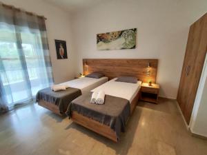 a bedroom with two beds with towels on them at Fontana 1-Bedroom House in Kavos