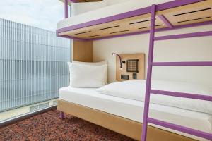 a bedroom with two bunk beds on a balcony at Hotelkonkurrenz Hostel in Nuremberg