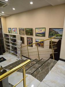 een kamer met een hoop schilderijen aan de muur bij Hotel-Apartment NMP in Tbilisi City