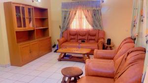 a living room with a couch and a table at AG appart'hôtel villas in Ouagadougou
