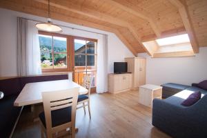 a living room with a table and a couch at Hölzlhof Apartments in Rasun di Sopra