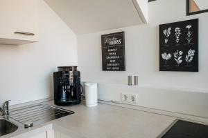 a kitchen counter with a coffee maker and a sink at Fantastic Loft with Balcony in Berlin
