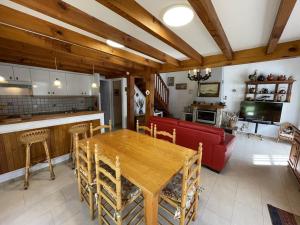 a living room with a wooden table and a red couch at Villa pour 6 à Soustons Plage avec parking privé - FR-1-379-116 in Soustons +7 photos