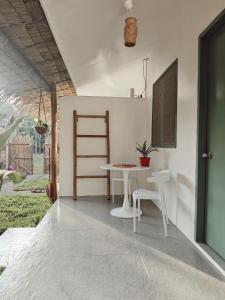 a dining room with a table and two chairs at Garden Village in El Nido