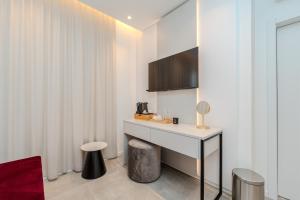 a room with a white desk and a table at Kolovare Luxury Rooms in Zadar