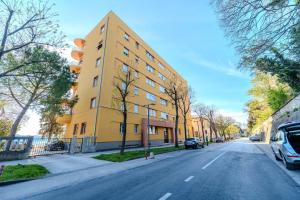 a yellow building on the side of a street at Kolovare Luxury Rooms in Zadar