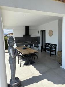 eine Statue in einem Wohnzimmer mit einem Tisch in der Unterkunft VILLA Azura 5 étoiles Vue panoramique in Sainte-Maxime