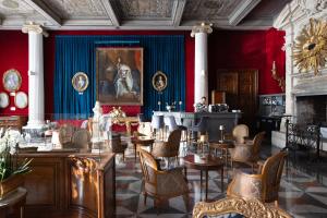 a dining room with red and blue walls and tables and chairs at Hotel Le Negresco in Nice