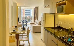 a kitchen with a table and a dining room at Aquarius Style by Holiday Stays in Fortaleza