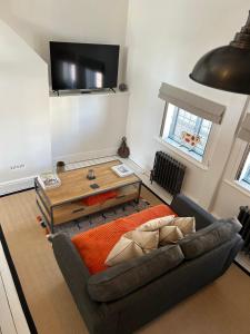 a living room with a couch and a table at The Hat Works in Ludlow