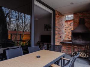 a dining room with a table and a fireplace at VAK Resort Dilijan in Dilijan
