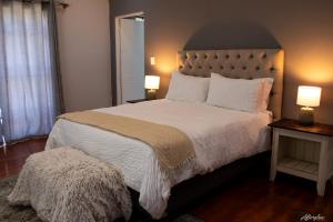 een slaapkamer met een groot bed met twee lampen bij NamaStay in Kaapstad