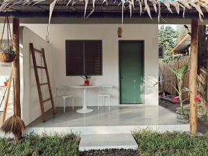 a patio with a table and a green door at Garden Village in El Nido +39 photos