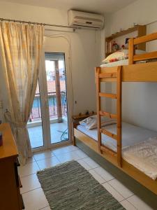 a bedroom with a bunk bed and a sliding glass door at Toroni home in Toroni