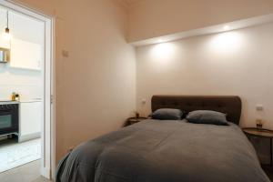 a bedroom with a bed with two pillows on it at Palmela 33 - in the Heart of Historic Center in Palmela