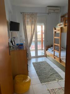 a room with a door open to a bedroom with a window at Toroni home in Toroni +12 photos