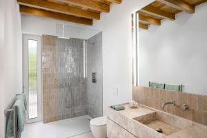 a bathroom with a sink and a toilet and a shower at Noordhoek Sunset Villa in Flat Acres +24 photos