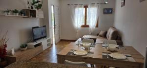a living room with a table and a couch at Riumar "Camins", 380m to beach, private pool, On-Site-Service, dog beach in Riumar