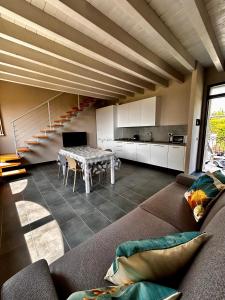 a living room with a couch and a table at Appartamenti Picedo in Polpenazze del Garda