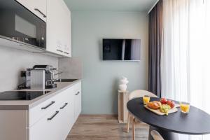 a kitchen with a table with a plate of food on it at kalm stay - munich east in Munich