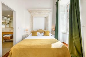 a bedroom with a large bed and a tub at Palmotta Palace in Dubrovnik