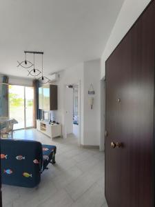 a living room with a blue couch and a table at Appartamento d' amare in Marzamemi +15 photos