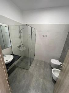 a bathroom with two toilets and a shower and a sink at Kristina Bellavista Rooms in Sarandë