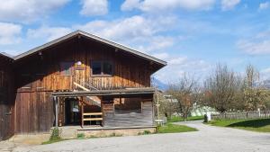 a large wooden barn with a porch at Heu und Himmel Loft in Innsbruck