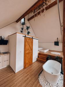 a bathroom with a bath tub and a wooden door at Luna by NorAtlas Heritage in Varlaam +19 photos
