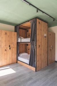 two bunk beds in a room with wooden walls at Estet Boutique Hotel in Astana