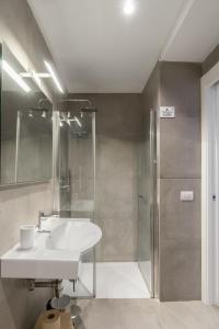 a bathroom with a sink and a shower at Napoli Visit Home in Naples +65 photos