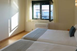 Posteľ alebo postele v izbe v ubytovaní Hotel Alda Fogar do Mariñeiro