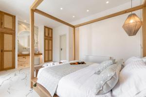 a bedroom with a large bed and a mirror at Elaia Home luxury village apartment for two Naxos in Galini