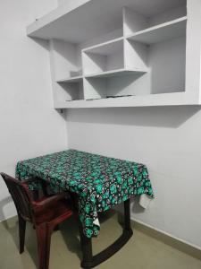 a small table with a green and white table cloth on it at Aswathy Bhavan in Vadakkāncheri