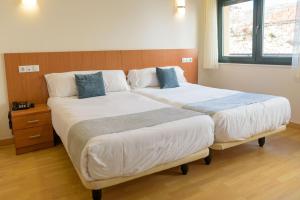 Posteľ alebo postele v izbe v ubytovaní Hotel Alda Fogar do Mariñeiro