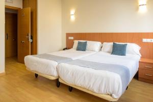 Posteľ alebo postele v izbe v ubytovaní Hotel Alda Fogar do Mariñeiro