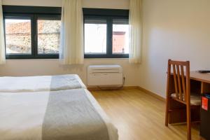 Posteľ alebo postele v izbe v ubytovaní Hotel Alda Fogar do Mariñeiro